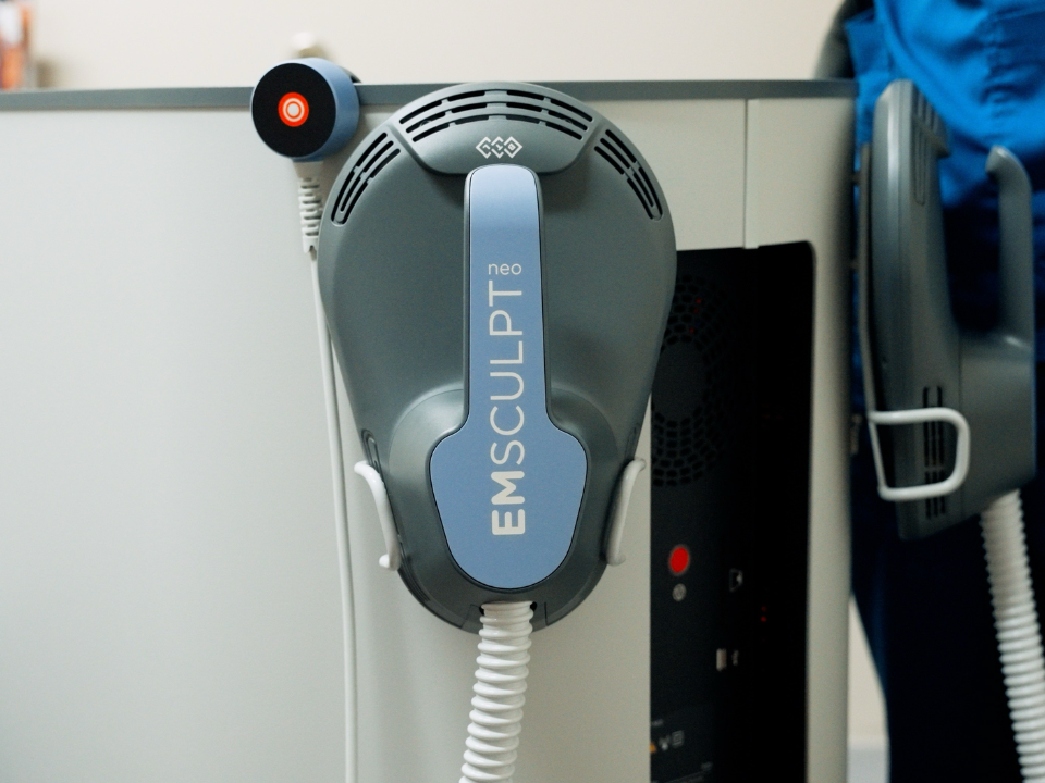 [Describe the real photo, e.g. the Emsculpt Neo device at RiverCrest Health]